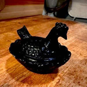 Miniature glass hen on nest.